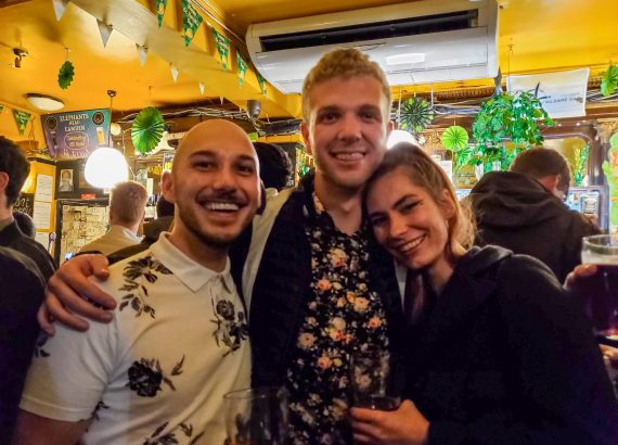 The author, his partner and friend pose for a photo at a London pub
