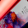 Galaxy S20 sitting on a neon colored light.