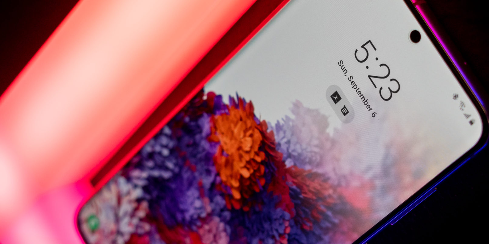 Galaxy S20 sitting on a neon colored light.