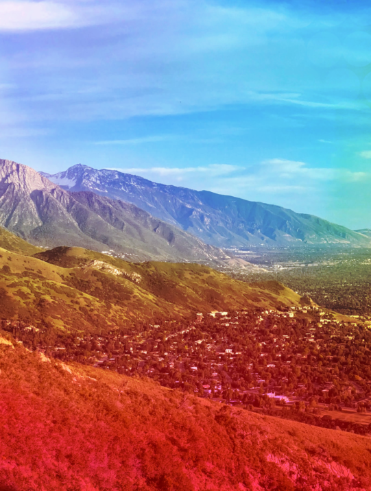 Panoramic view of the Salt Lake Valley with rainbow Pride gradient overlay