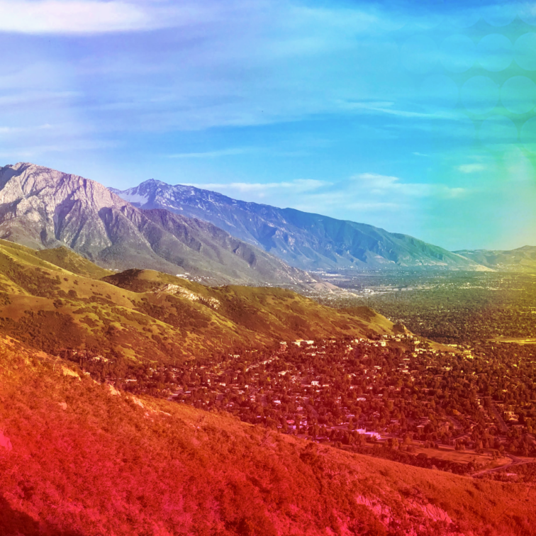 Panoramic view of the Salt Lake Valley with rainbow Pride gradient overlay