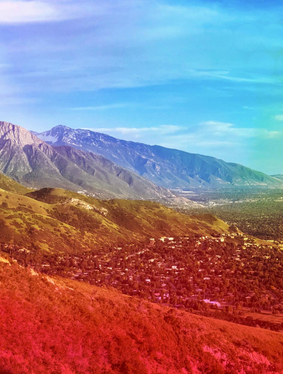 Panoramic view of the Salt Lake Valley with rainbow Pride gradient overlay